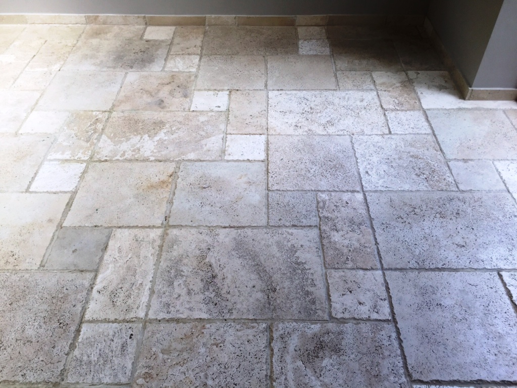 Pitted travertine floor tiles before cleaning in Andover